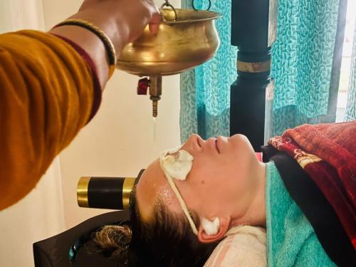 a woman getting her teeth washed at a dental clinic at Krishnabalram wellness & Ayurveda centre in Rishīkesh