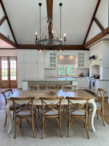 a kitchen with a large wooden table and chairs at Ciel House - French style in Angaston