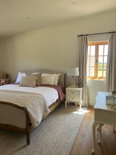 a bedroom with a large bed and a window at Ciel House - French style in Angaston