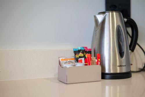 a toaster sitting on a counter next to a box at Habitat Aparthotel by Totalstay in Cape Town