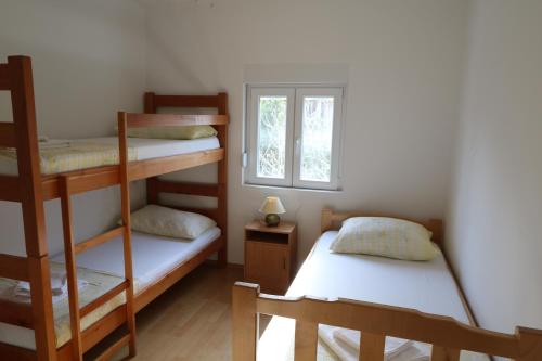 a bedroom with two bunk beds and a window at Antodo Alen in Novalja