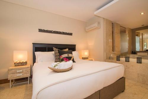 a bedroom with a large white bed with two lamps at Luxury Romance - 5 to Beach in Casuarina