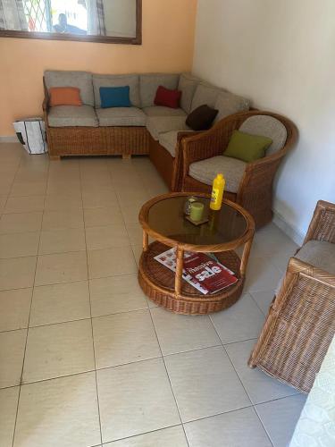 a living room with a couch and a coffee table at La Casa Familia in Grand Gaube