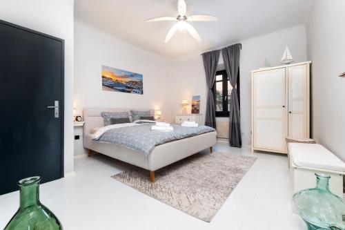 a bedroom with a bed and a ceiling fan at Atrium Town House in Rovinj