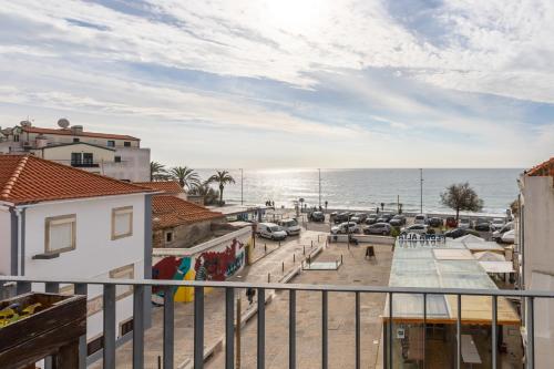 a view of the ocean from a balcony at Casa da Praça Guest House in Sesimbra