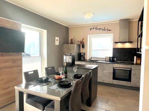 a kitchen with a table with chairs and a dining room at Ferienwohnung Sonnenterrasse, 1-4 Personen, 2 Schlafzimmer, große Terrasse in Müden
