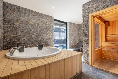 a bath tub in a bathroom with a wooden deck at Camelia 9 in Alanya