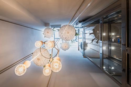 a room with several lights hanging from a wall at B&B Il Palazzotto di Luca Luxury Suites in Lecce