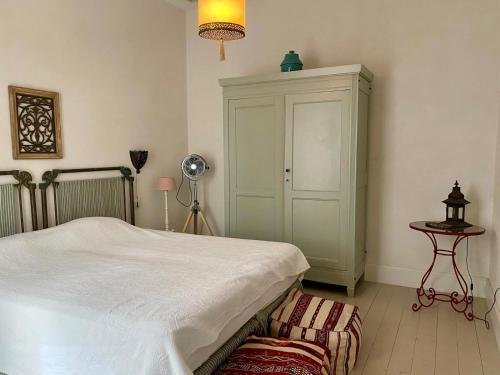 a bedroom with a bed and a dresser and a lamp at CASA PALACIO PRIVADO EN CADIZ CAPITAL - by Andalusian Glory in Cádiz