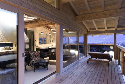 a large room with a bedroom and a living room at HELD - Hotel & Spa , 4 Sterne Superior, Zillertal in Fügen