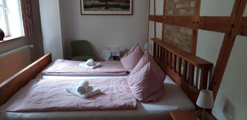 two beds in a room with towels on them at 75 qm Ferienwohnung für 4 Personen am Naturschutzgebiet Anklamer Stadtbruch in Bugewitz