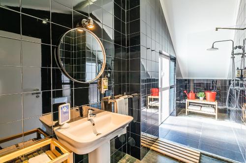 a bathroom with a sink and a shower at Emporium Lisbon Suites in Lisbon