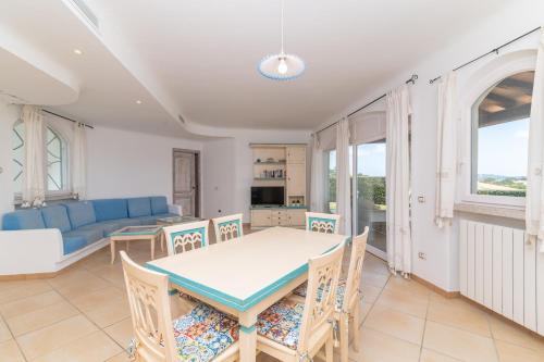 a living room with a table and chairs and a couch at Villa Maddalena in Porto Rafael