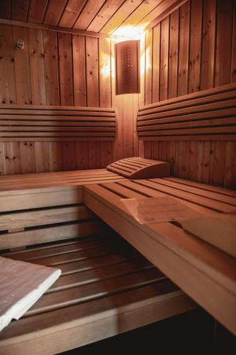 an empty sauna with wooden walls and wooden floors at HELD - Hotel & Spa , 4 Sterne Superior, Zillertal in Fügen