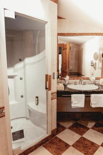 a bathroom with a shower and a sink at HELD - Hotel & Spa , 4 Sterne Superior, Zillertal in Fügen