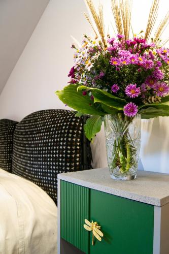 a vase of flowers sitting on top of a table at Drzemka in Ruda