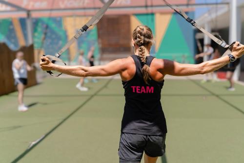 a woman is holding onto ropes in a gym at Playitas Hotel - Sports Resort in Las Playas