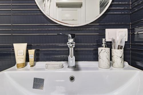 a bathroom with a sink and a mirror at Botanic Urban Cozy in Astana