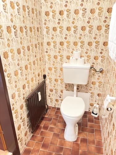 a bathroom with a toilet and a tiled floor at Apartments Steinwänd in Grünau im Almtal