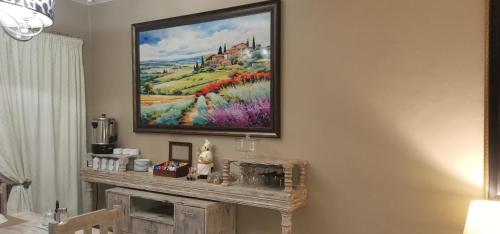 a painting hanging on a wall above a fireplace at Giardino a 194 in Welkom