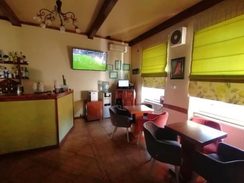 a restaurant with brightly colored walls and tables and chairs at Vila Veche in Haţeg