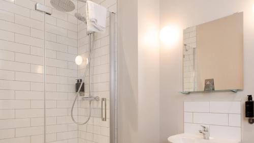 a bathroom with a shower and a sink at Marine Hotel Ballycastle in Ballycastle