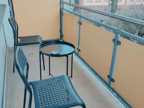 two chairs and a table on a balcony at Gleaming Apartment in Mettmann in Mettmann