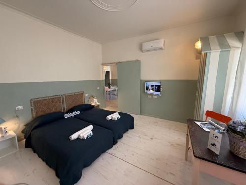 a bedroom with two beds with towels on them at House Farorosmarino by Holiday World in Chiavari