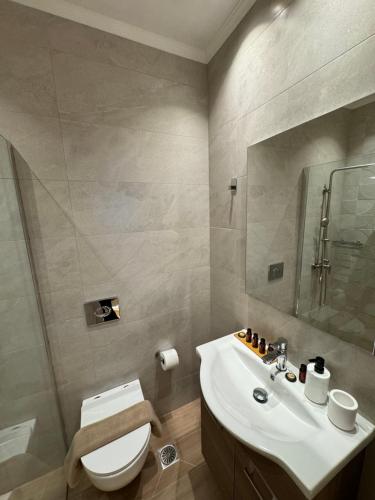 a bathroom with a white toilet and a sink at City Compass Sunset Villa in Rhodes Town