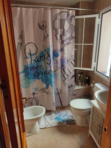 a bathroom with two toilets and a shower curtain at Apartamento torrox in Torrox Costa