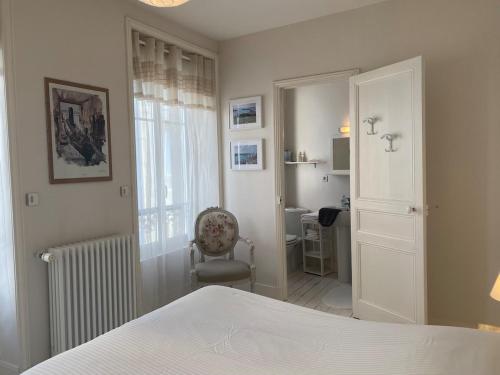 Un dormitorio con una cama y una silla y una ventana. en Villa Patton, en Granville