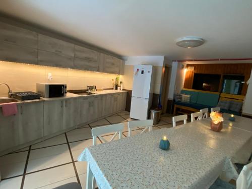 a kitchen with a table and a white refrigerator at Lélek-Tér in Siófok