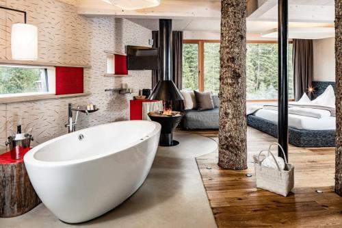 a bathroom with a large white tub in a room at Caravan Park Sexten in Sesto