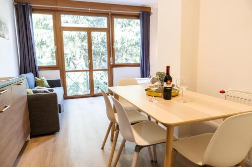 a dining room with a table and chairs with wine glasses at Flow Apartments WINKEL STUDIO in Merano