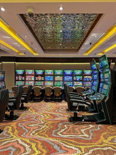 a casino with many slot machines in a casino at Hotel London 1889 & Casino in Batumi