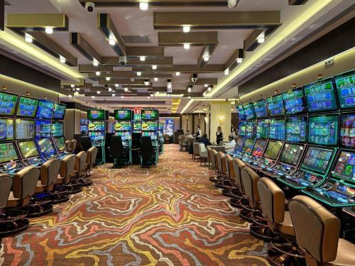 a casino with a bunch of slot machines at Hotel London 1889 & Casino in Batumi