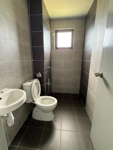 a bathroom with a toilet and a sink at The Barakat Homestay in Semenyih