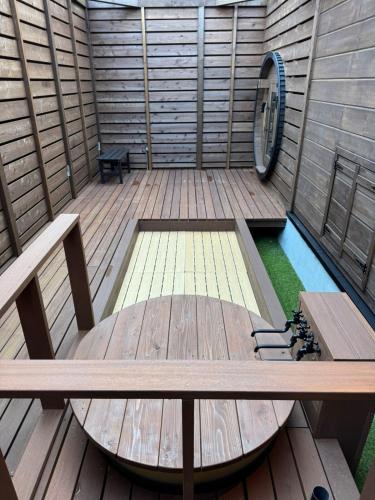 an inside of a sauna with a table and a pool at P's Wood 箱根仙石原 in Hakone