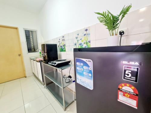a room with a refrigerator with a clock on it at Koi Kinrara 2 Room Puchong IOI Bkt Jalil Pavillion Sunway Pyramid Lagoon Hospital Old Klang Road in Puchong