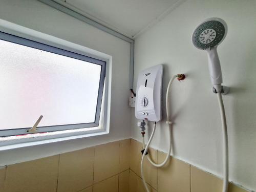 a shower in a bathroom with a window and a blow dryer at Koi Kinrara 2 Room Puchong IOI Bkt Jalil Pavillion Sunway Pyramid Lagoon Hospital Old Klang Road in Puchong