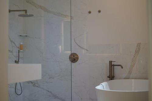 a bathroom with a shower with a tub and a sink at Tenuta San Marco in Noto