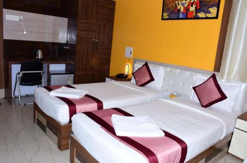 a hotel room with two beds in a room at AR Grand HOTEL in Rājgīr