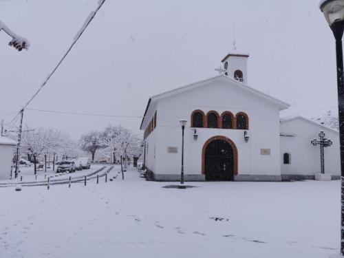 a large white church with snow on the ground at Cueva Abuelo Juan in Guadix