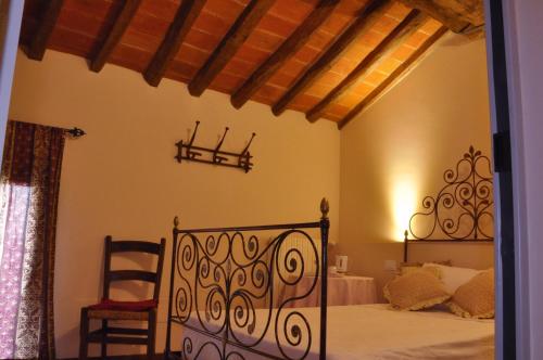 a bedroom with a bed and a chair in it at Villa Cantoni in Gropello Cairoli