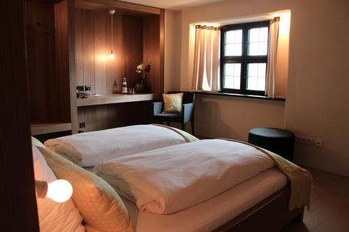 a hotel room with two beds and a window at Burg Falkenberg in Falkenberg