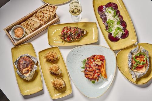 a group of plates of food on a table at Lindos Royal Resort in Líndos
