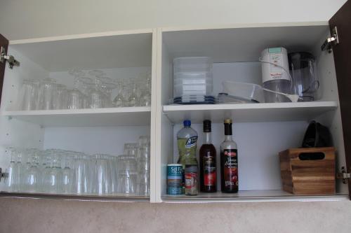 a cabinet filled with glasses and bottles of alcohol at Ma Ré'Son Salée in Loix