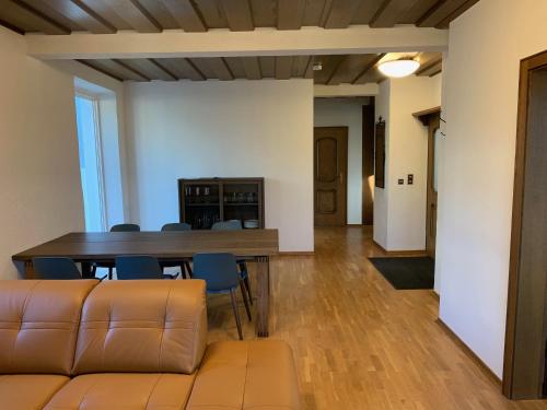 a living room with a couch and a table and chairs at Villa mit Pool und Grillplatz in Regensburg in Regensburg