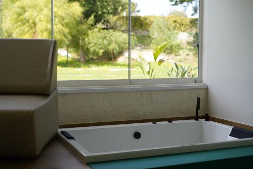 a bath tub sitting in front of a window at Tenuta San Marco in Noto