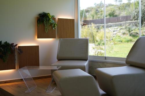 a waiting room with two chairs and a table and a window at Tenuta San Marco in Noto